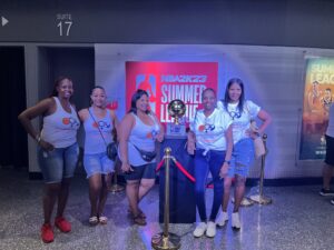 People inside an event venue posing with an award