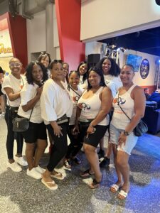 A group of women in white tops at an event
