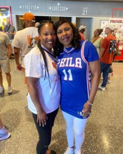 Two women wearing white and blue shirts