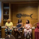 Five women sitting and having a conversation