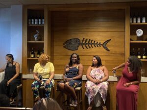Five women sitting and having a conversation
